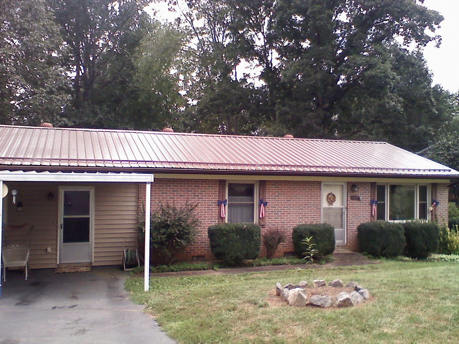Bronze metal roof and carport on a brick ranch home — Roof Repair work by our crew in Barrytown